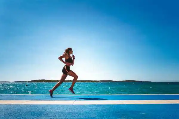 Woman running showing strong leg muscle Liverpool